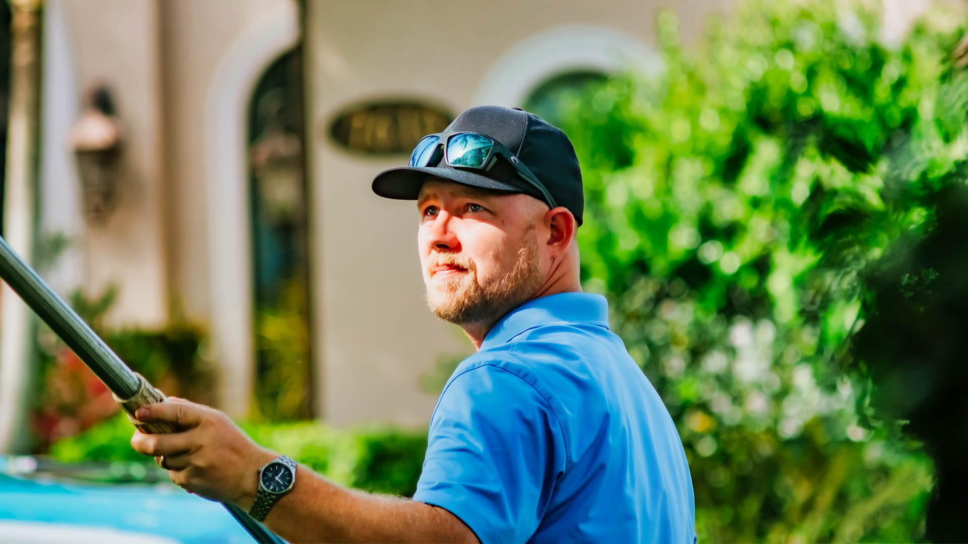 Best Power Washing and Pressure Cleaning Company in Naples, Florida - Elegant Styles, owned by Shaun Duncan, pictured performing exterior cleaning on a home in Naples, FL
