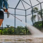 Elegant Styles Power Wash team performing walkway pressure washing in Naples, Florida, showcasing the benefits of regular cleaning for safety and aesthetics.