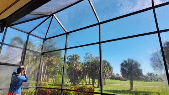 Professional pool cage cleaning service in Naples, FL removing mold and debris by Elegant Styles Power Wash.