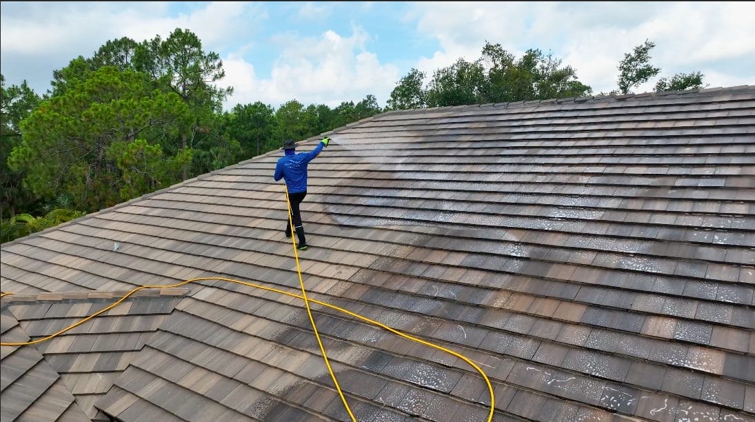 Professional roof pressure washing in Naples, FL removing dirt, algae, and mold to enhance energy efficiency, curb appeal, and roof longevity.