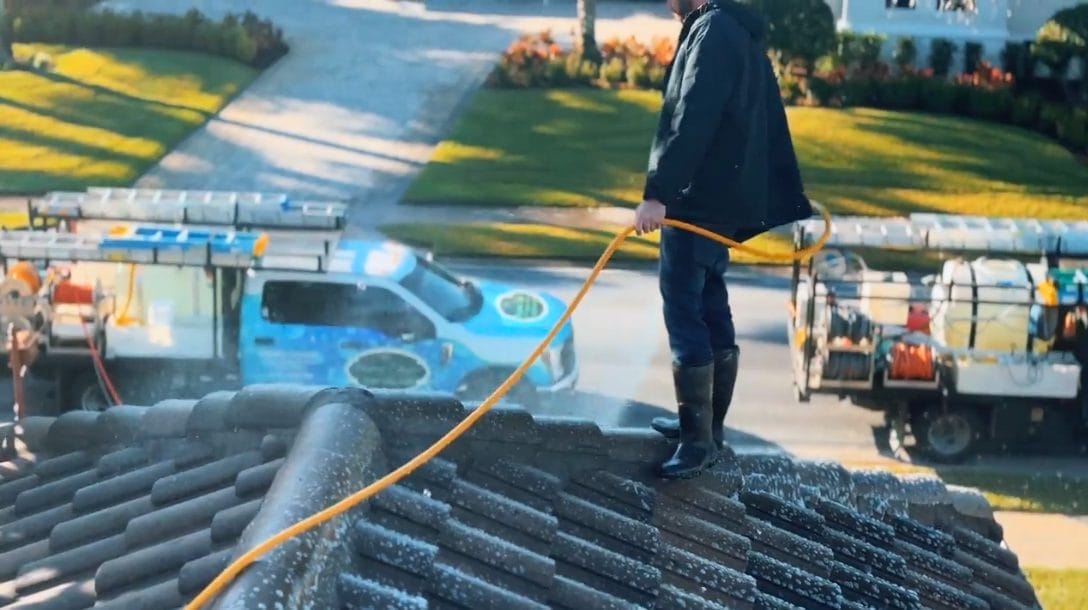 Professional roof cleaning service removing algae and moss in Naples, FL by Elegant Styles Power Wash.