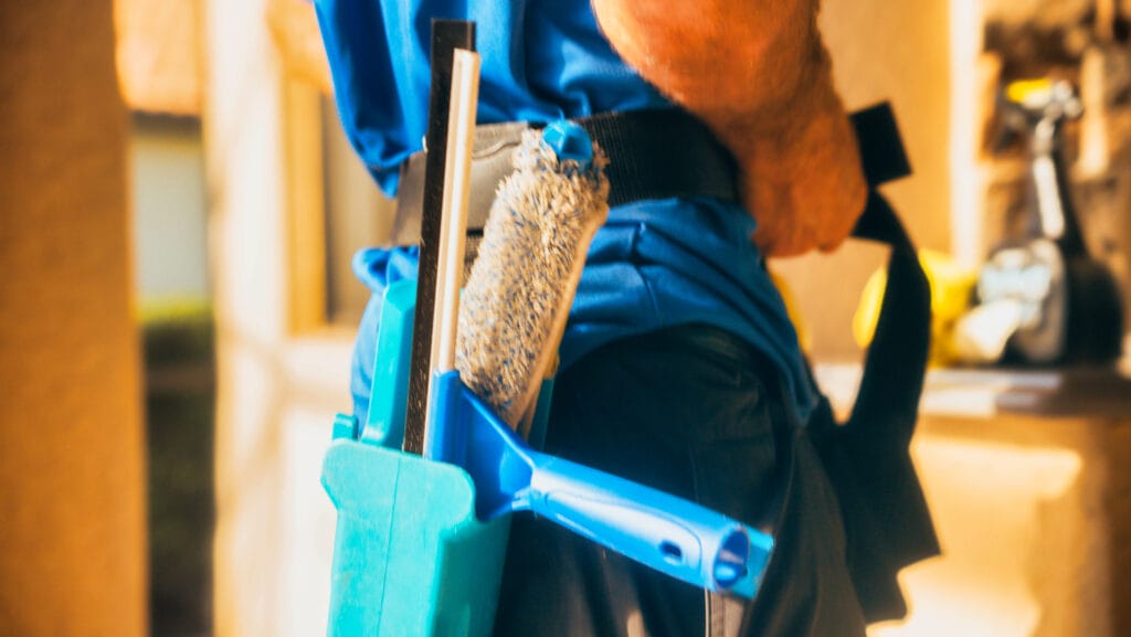 Elegant Styles Power Washing technician cleaning exterior windows in Naples, Florida