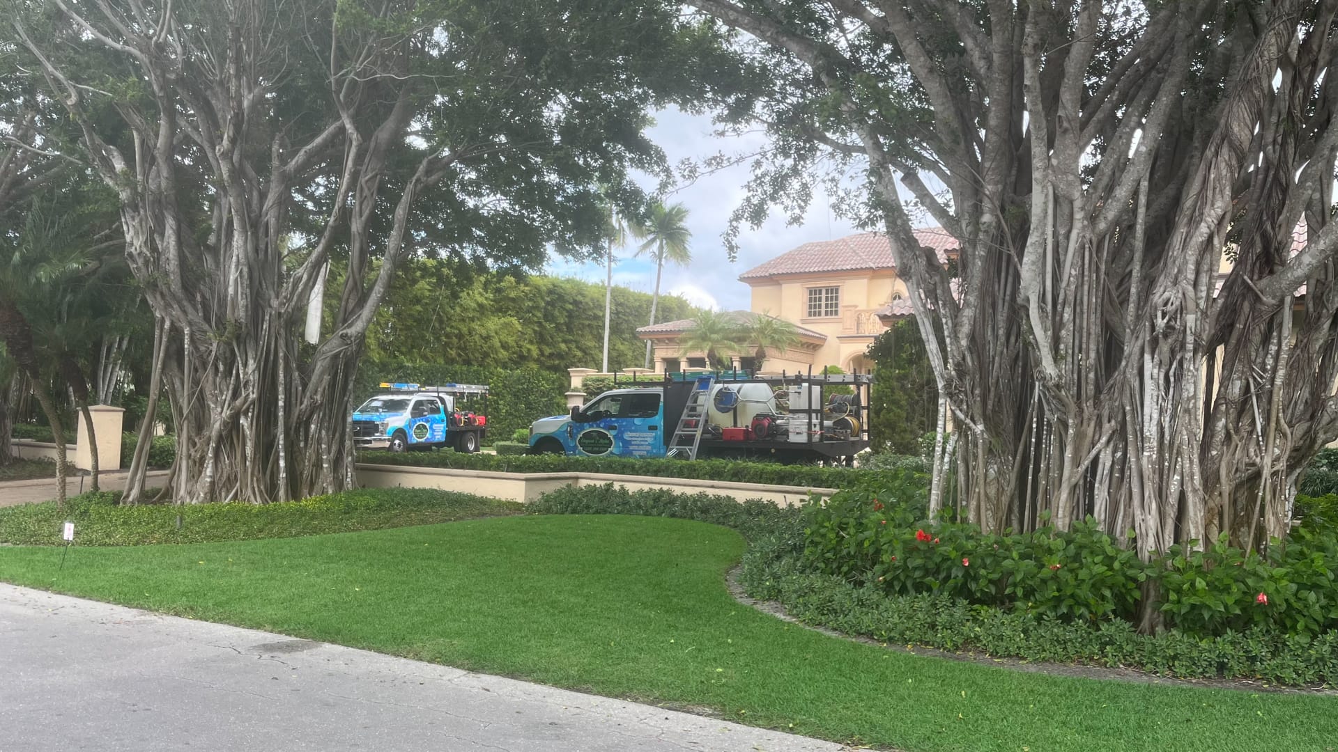 Elegant Styles Power Washing team cleaning a residential home exterior in Old Naples, Florida, enhancing curb appeal and property value